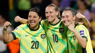 Sam Kerr, Emily van Egmond and Caitlin Foord wearing Matildas shirts and celebrating