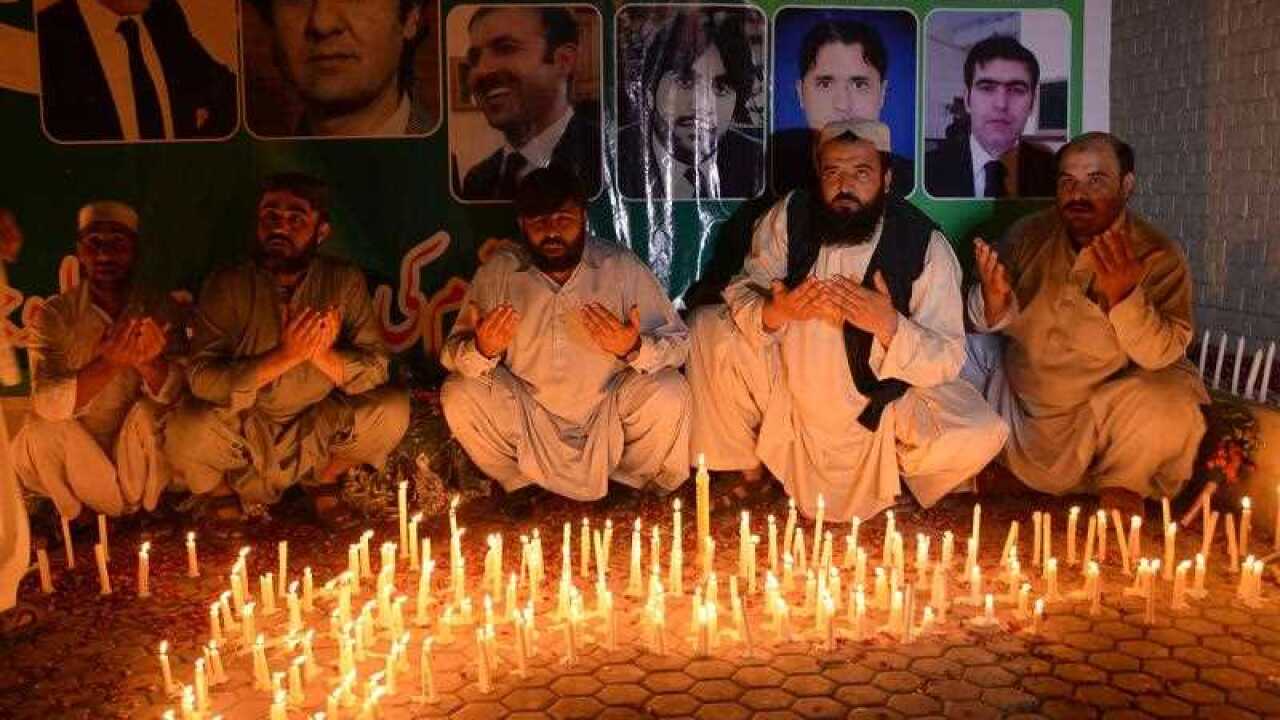 People light candles and pray for the victims at a site Monday's suicide bombing, in Quetta, Pakistan, Tuesday, Aug. 9, 2016.