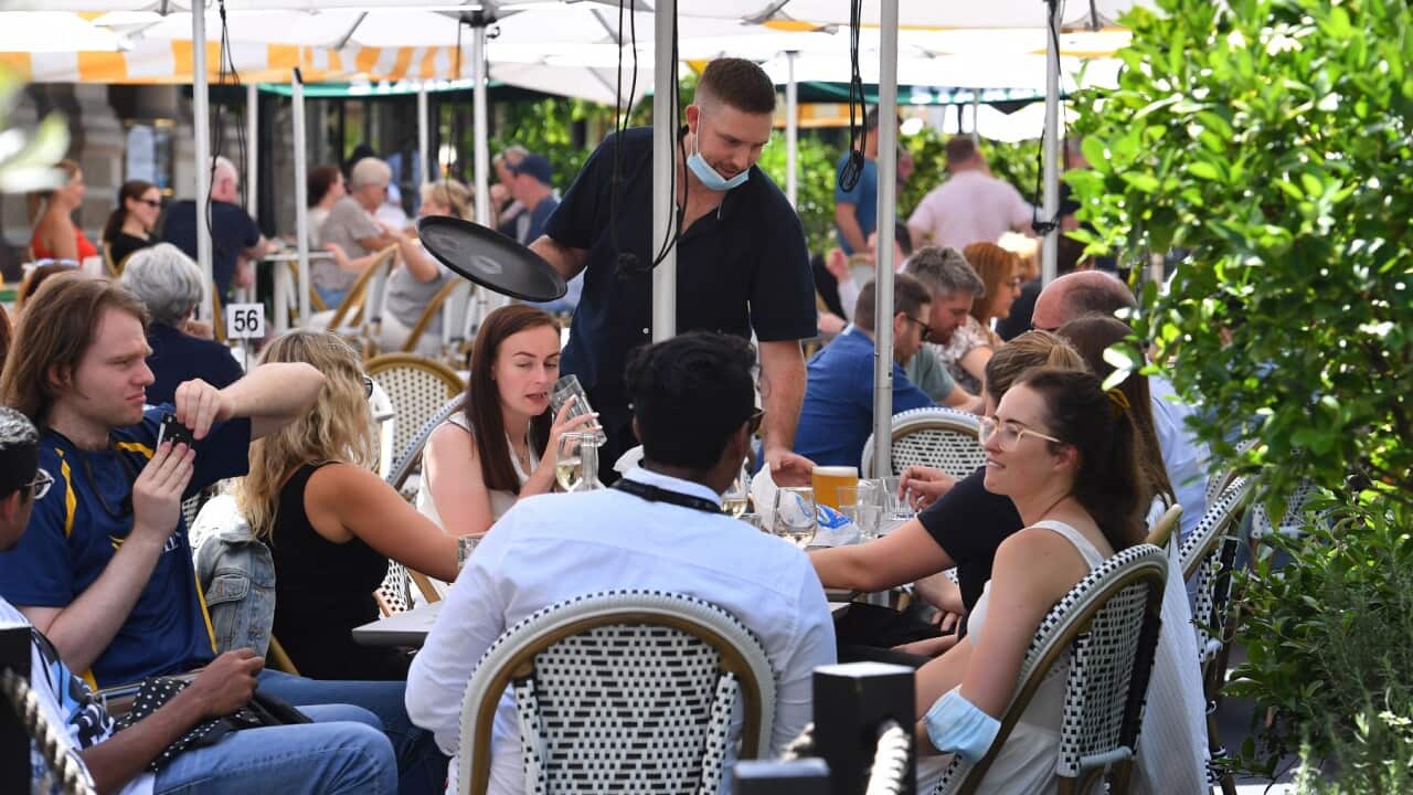 Diners enjoy lunch after density limits of 1 person per 2 square meters were scrapped for many venues following a change in New South Waless COVID restrictions in Sydney, Friday, February 18, 2022. Australia's two most-populous states will ease many of th