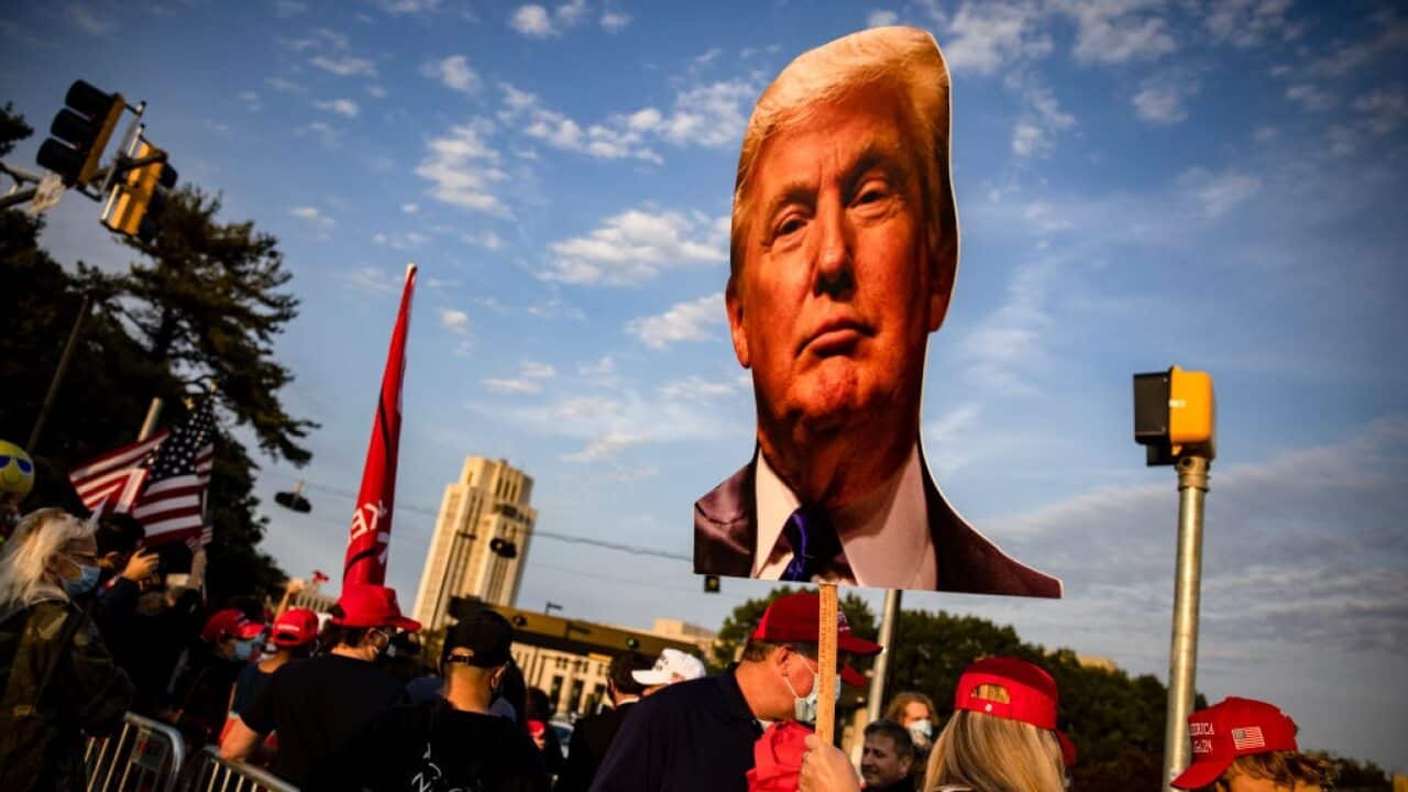 Supporters of President Donald Trump gather outside Walter Reed hospital after the president was admitted for treatment of COVID-19.