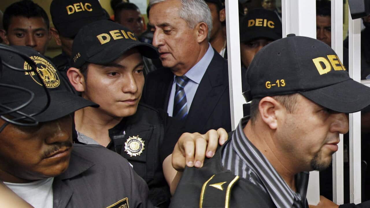 Guatemala's former President Otto Perez Molina is escorted as he leaves the court after his second hearing in Guatemala City, Friday, Sept. 4, 2015. (AP Photo/Moises Castillo)