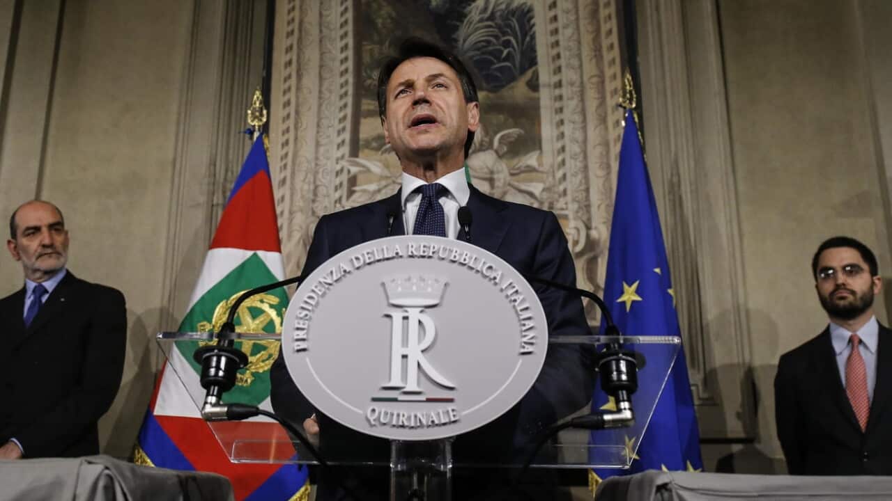 Italian Prime Minister-designate Giuseppe Conte (R) addresses the media to announce his list of ministers 