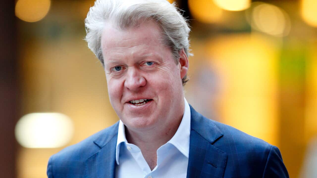 A middle-aged white man in a navy suit