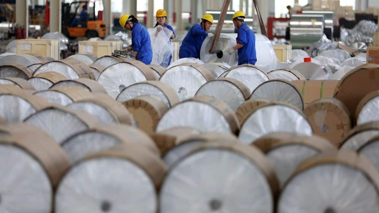 This photo taken on May 20, 2017 shows Chinese workers packaging aluminium tapes at an aluminium production plant in Huaibei, east China's Anhui province. / AFP PHOTO / STR / China OUT (Photo credit should read STR/AFP/Getty Images)