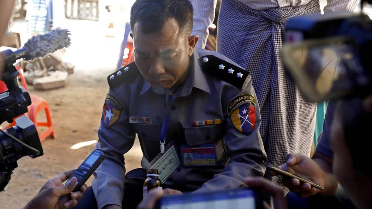 Prosecution witness police captain Moe Yan Naing  surrounded by journalists outside the court in Yangon, Myanmar.