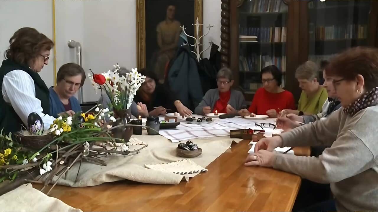 Biserka Vucenik teaching pensioners how to make black eggs (AP).jpg