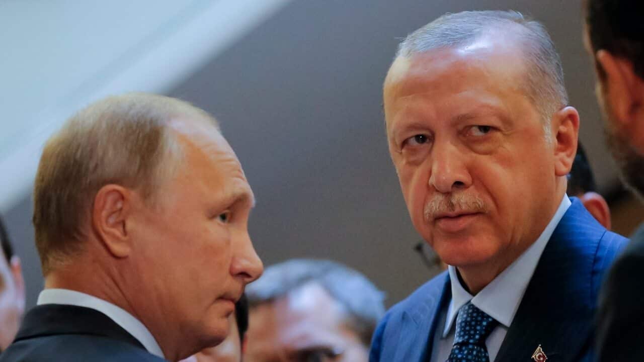 Russian President Vladimir Putin, (L) and Turkish President Recep Tayyip Erdogan prepare to enter a hall for their talks in the Bocharov Ruchei residence