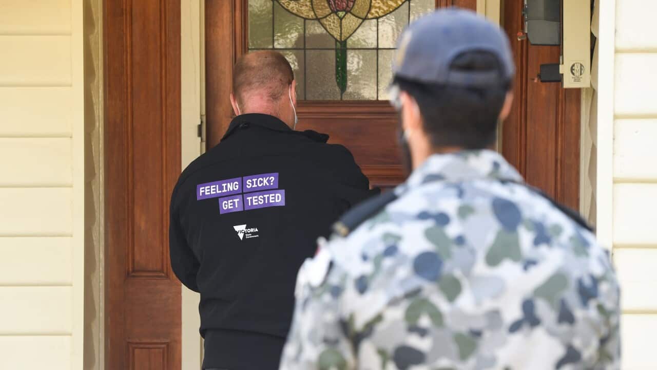 A government health official conducts a welfare check in Brunswick West, Melbourne