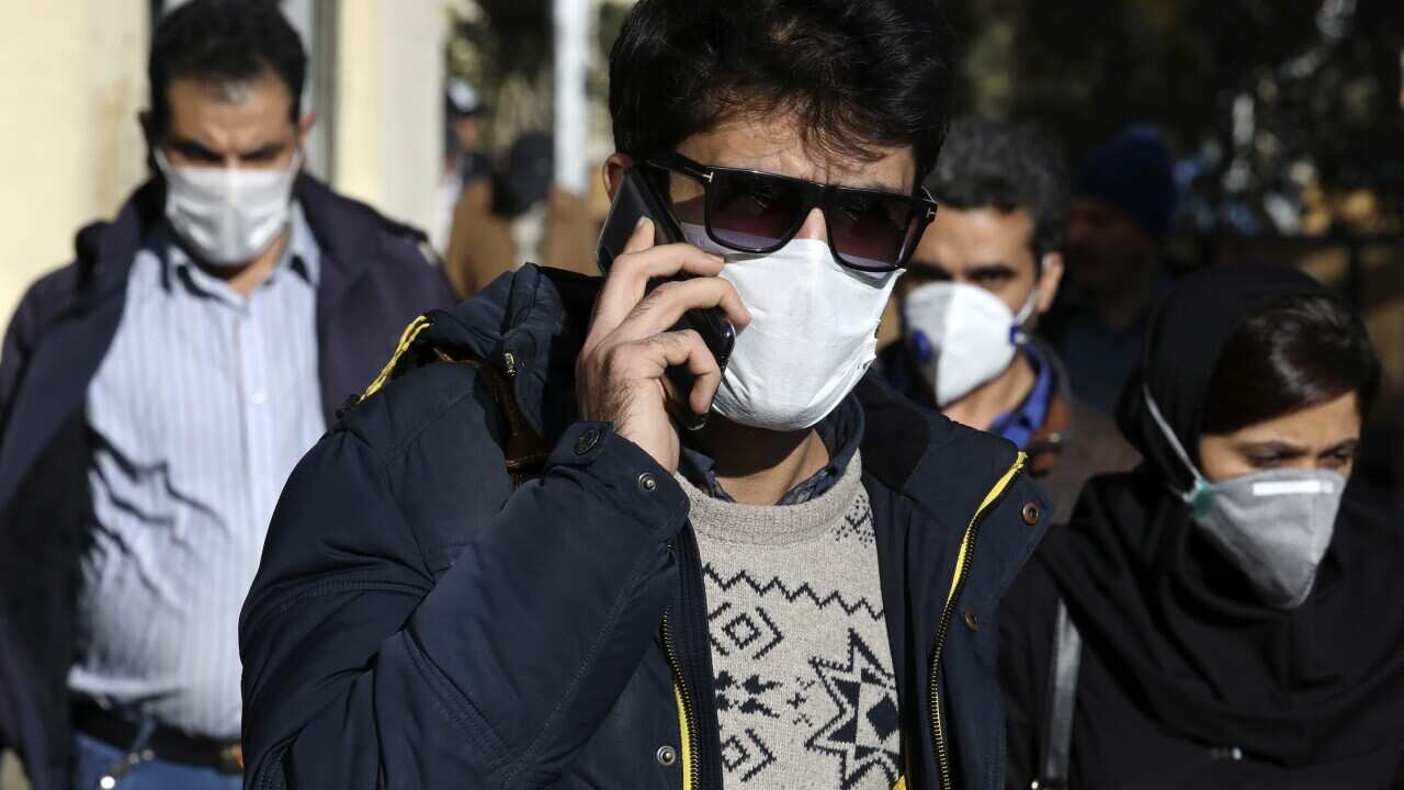A man speaks on his cellphone wearing a face mask in downtown Tehran, Iran, Monday, 2 March, 2020.