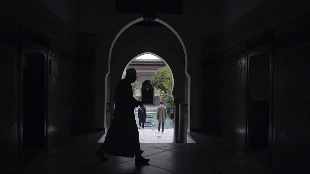 A man walks inside the Paris mosque on 29 October.