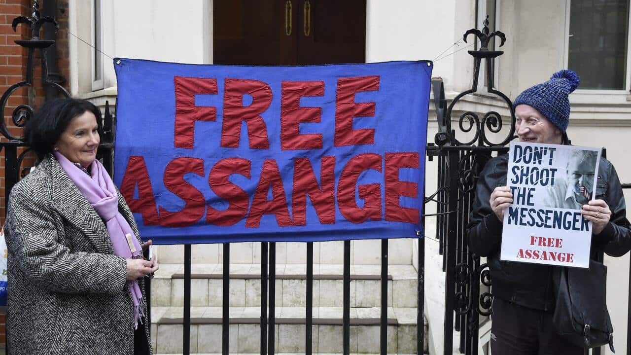 Supporters of Julian Assange stand outside the Ecuadorian Embassy in London