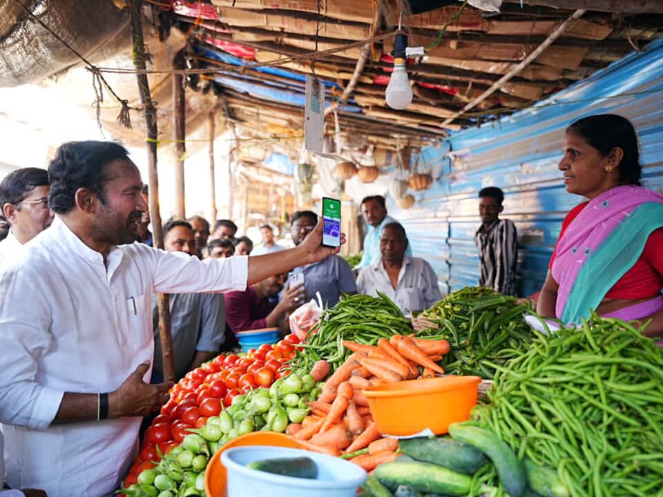 India: G. Kishan Reddy makes a payment through the UPI to a vegetable seller at a roadside market in Jubilee Hills