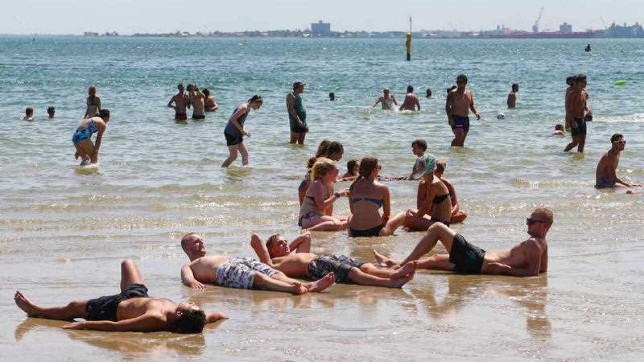 Bathers try to cool off in the hot weather at St Kilda Beach in Melbourne