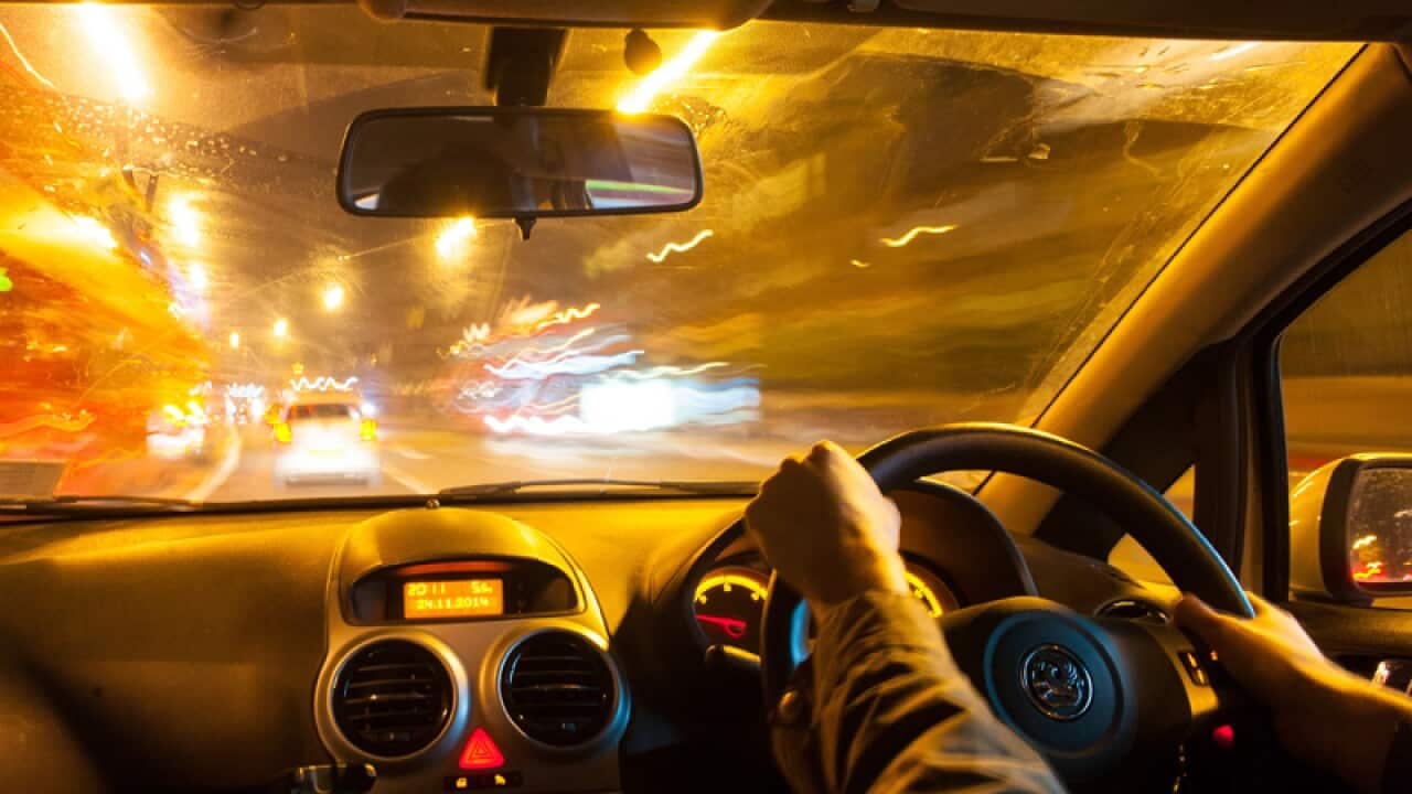 A man driving a car in traffic
