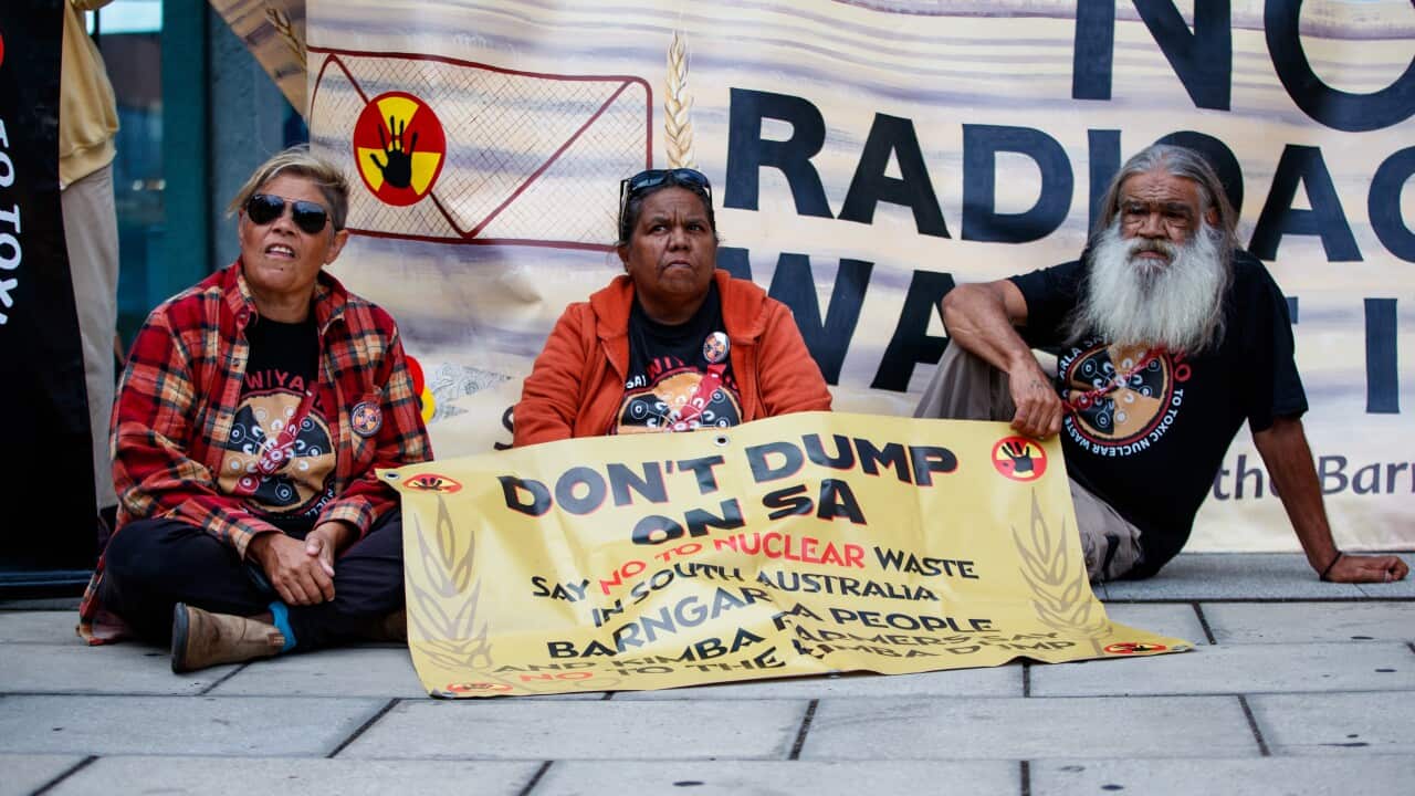Traditional owners with protest signs