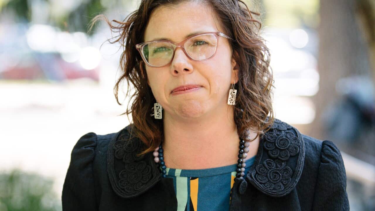 A woman standing at a microphone.