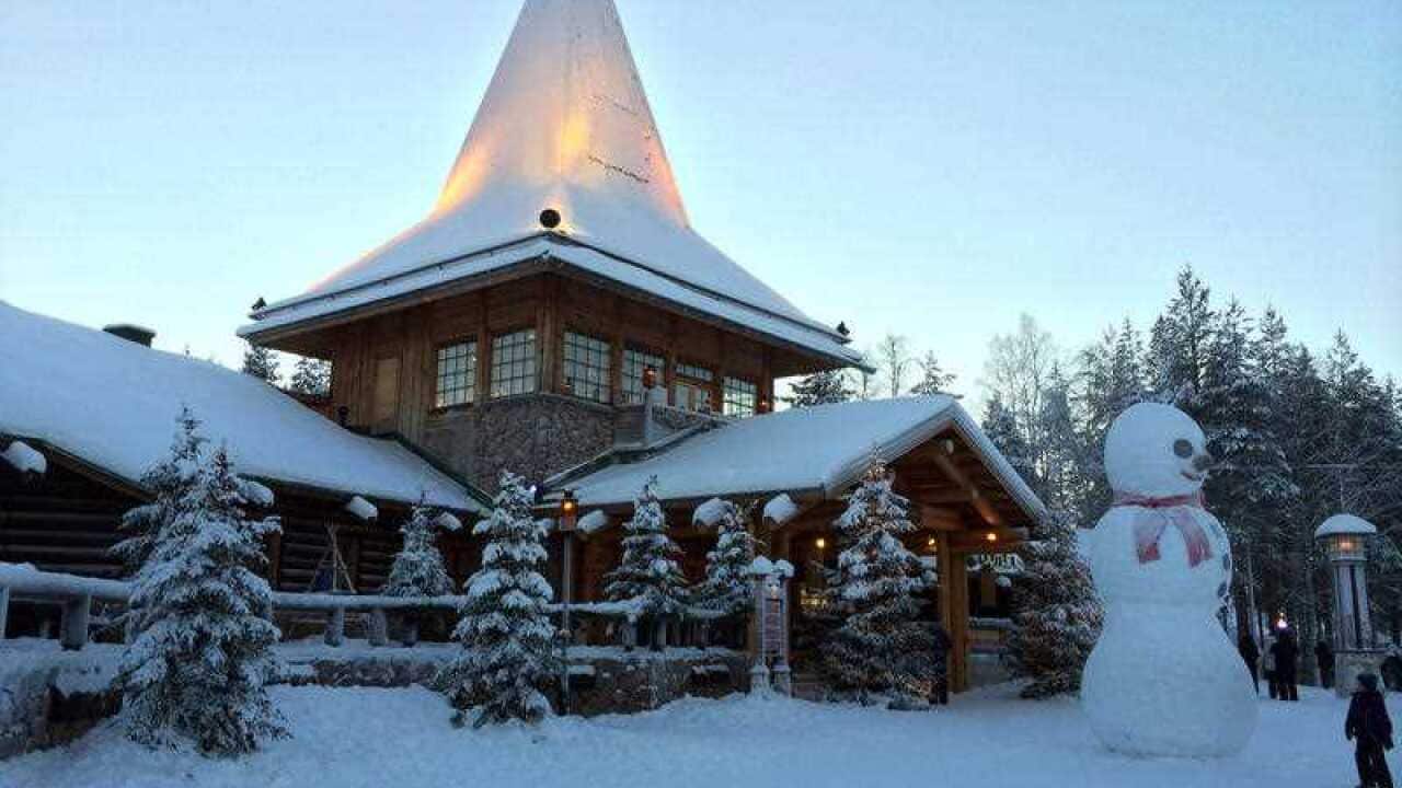 A child looks at a large snowman in Santa Claus Village, around 8 kms, 5 miles north of Rovaniemi in Finland