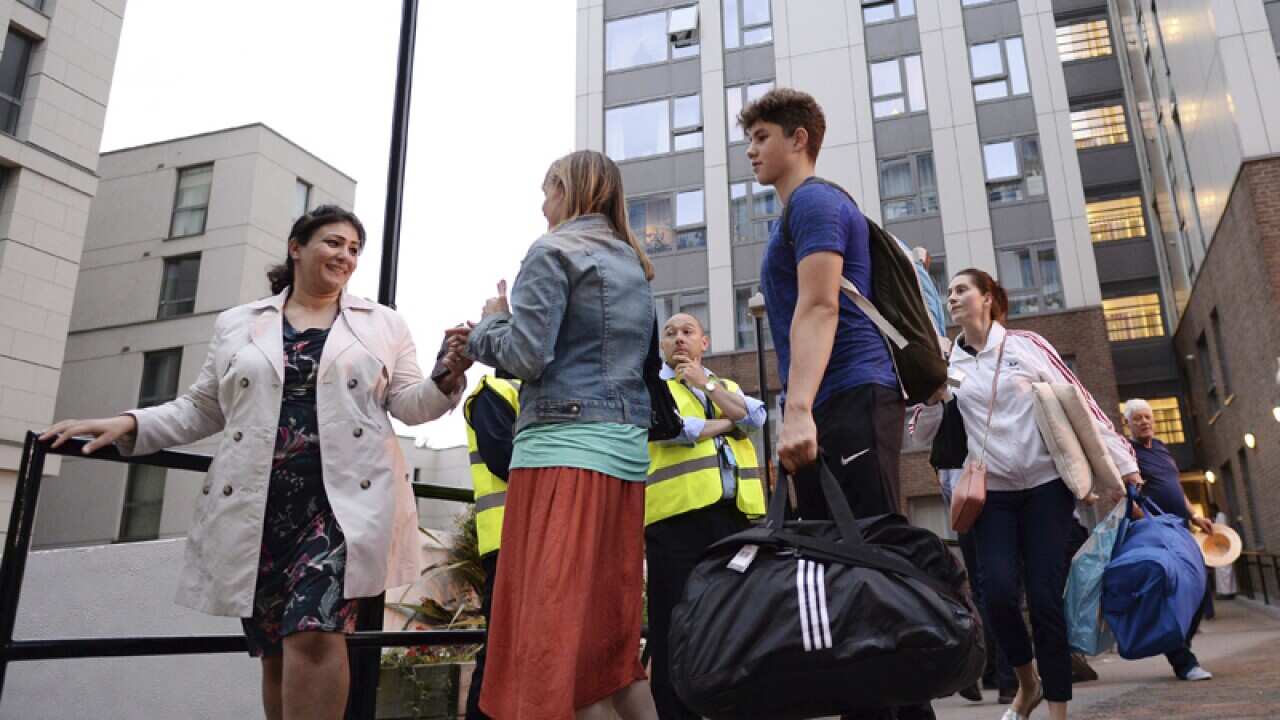 Residents leave a residential tower block in Camden