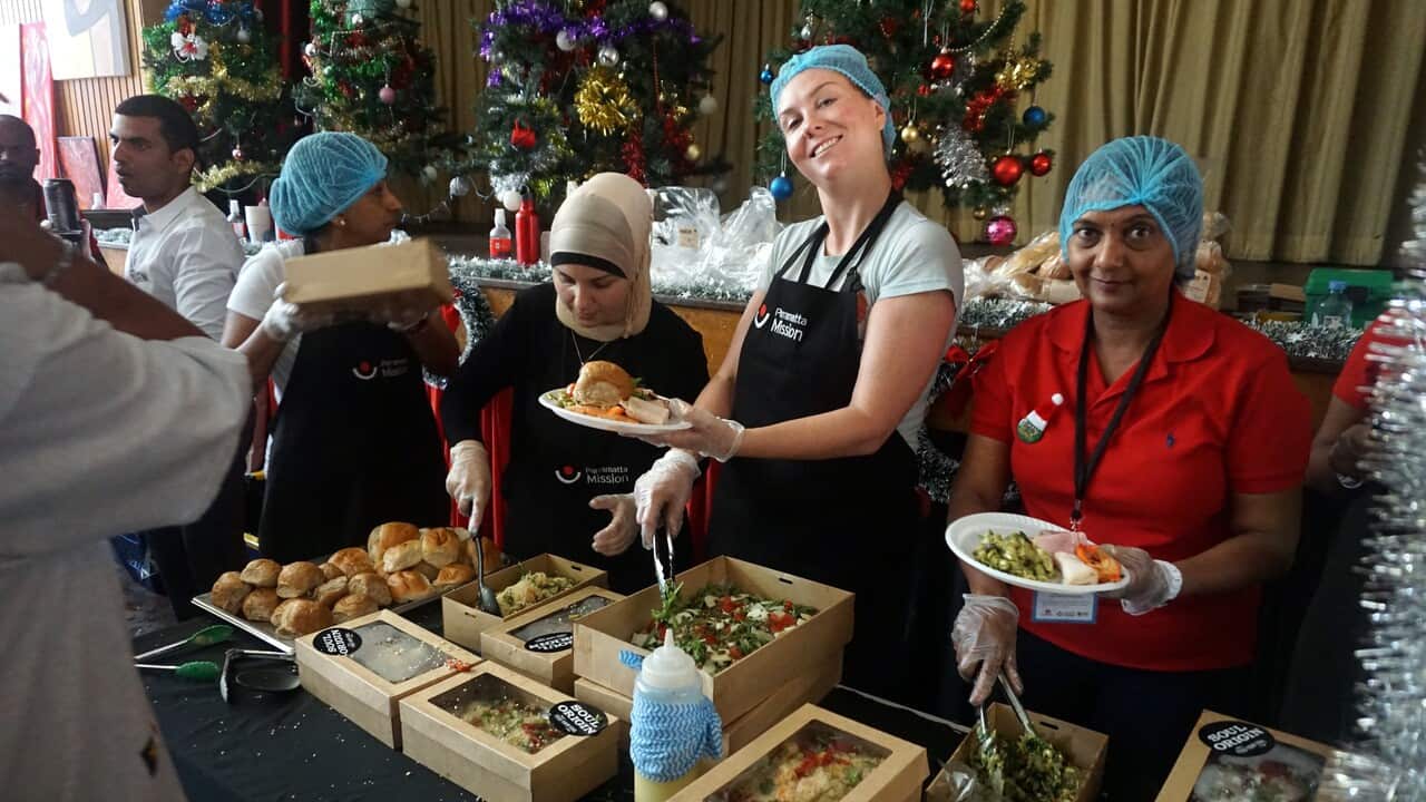 Volunteers serve people who attended Parramatta Mission's Christmas lunch in Sydney.