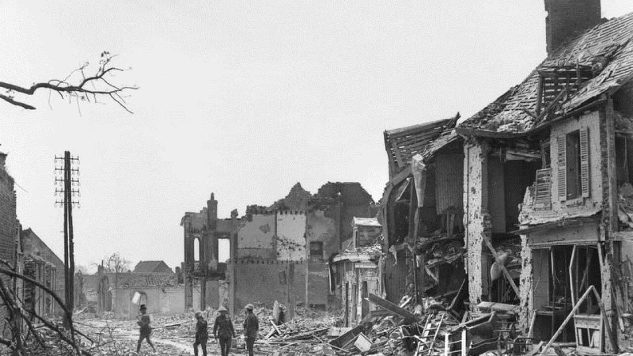 Four unidentified soldiers inspecting the ruins of Villers-Bretonneux.