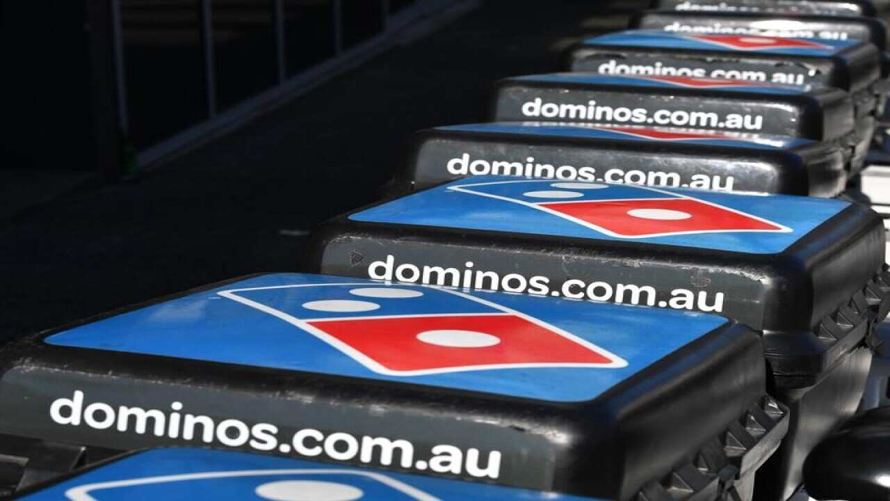 Domino's Pizza delivery bikes are seen outside a Domino's store.