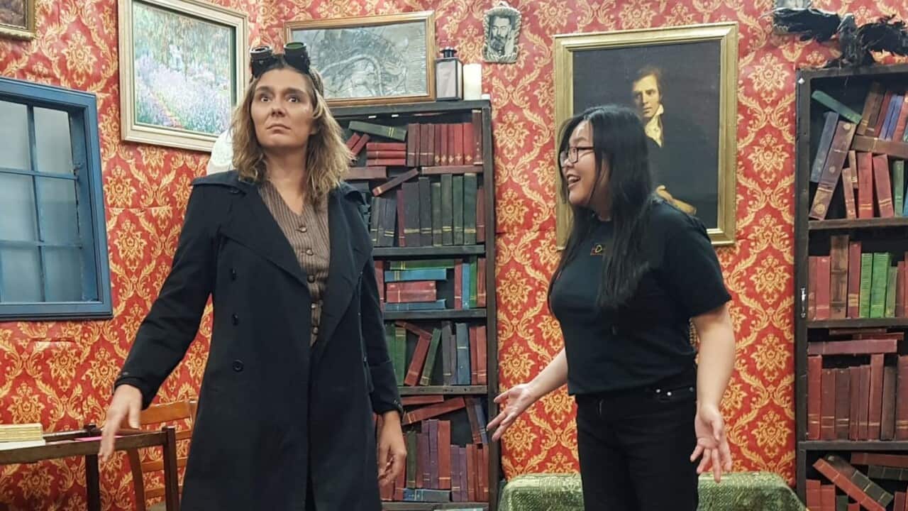 Two women on stage in an improvised theatre show.