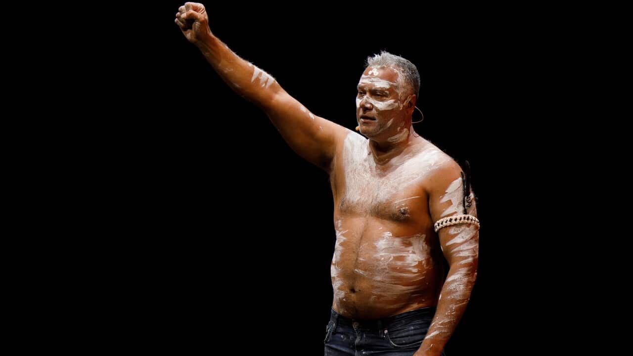 A man raises his fist.