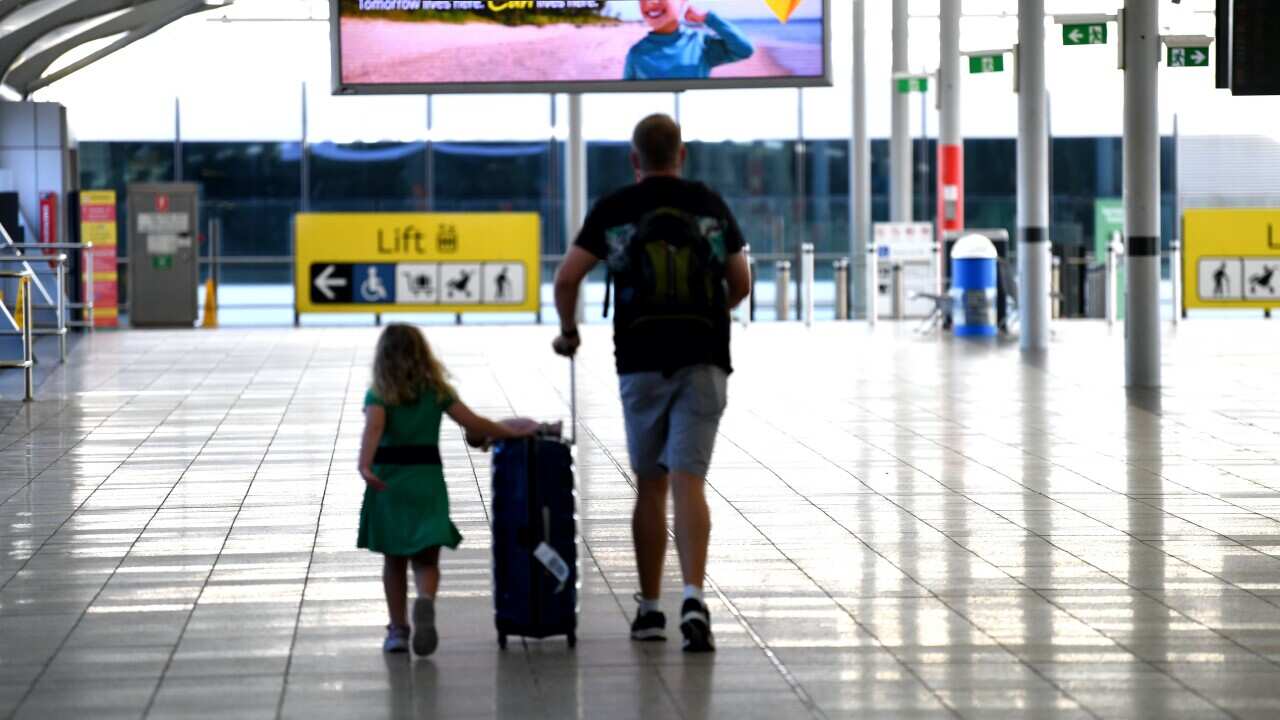 Departing passengers make their way to the domestic terminal in Brisbane airport in December 2020.