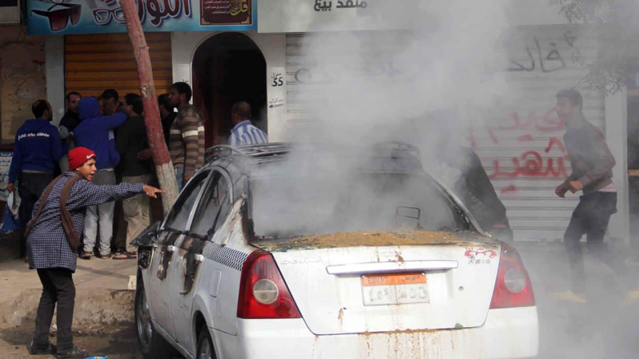 A car burns after events for the anniversary of the 2011 uprising