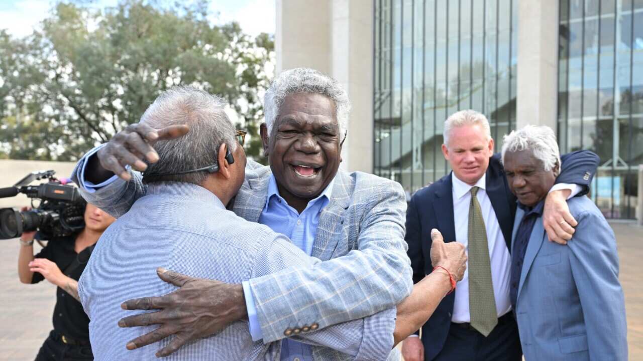 Gumatj leaders Djawa Yunupingu and Balupalu Yunupingu celebrate outside the High Court of Australia in Canberra (AAP)