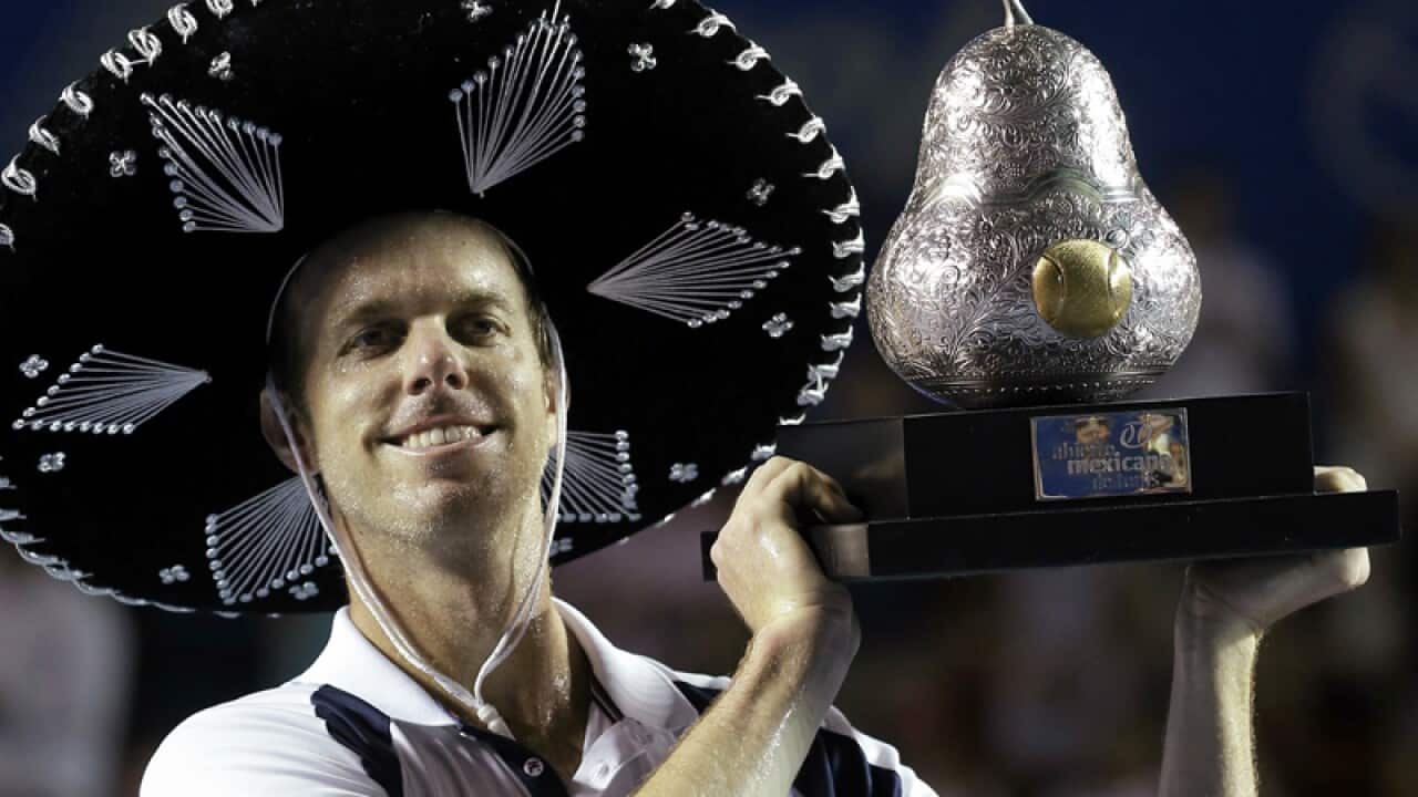 Sam Querrey of the USA poses with the trophy