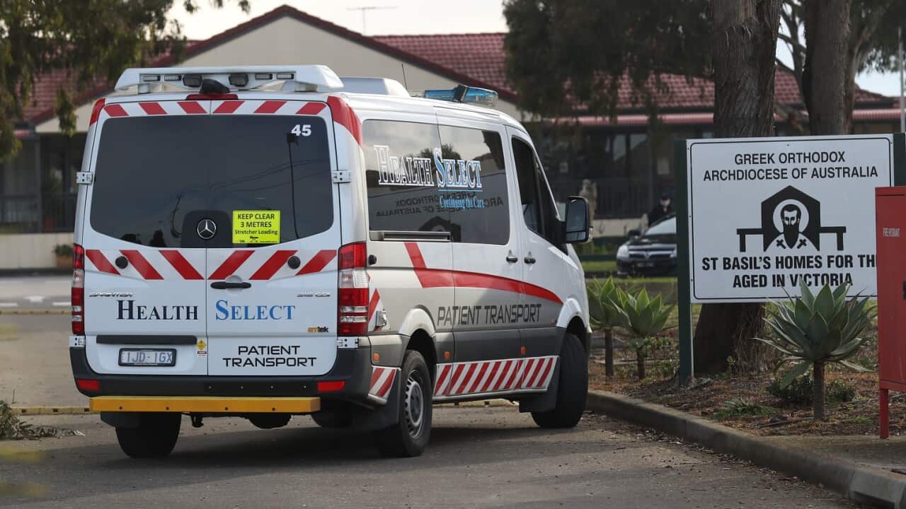 Medical staff are seen preparing to transport people from the St Basils Home for the Aged Care in Fawkner