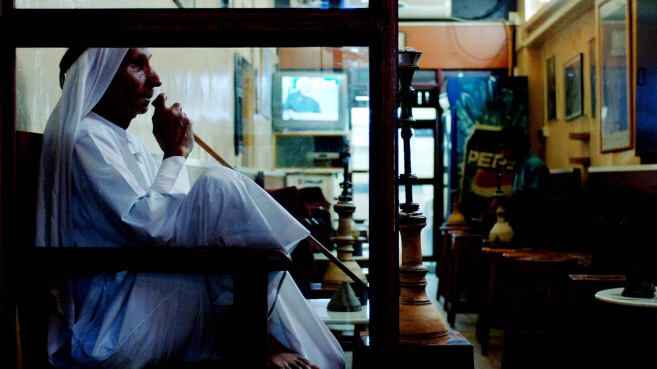 A man smokes a pipe in a cafe at the Souq Waqif in Doha, State of Qatar, Wednesday, Nov. 29, 2006. (AAP Image/Tracey Nearmy)