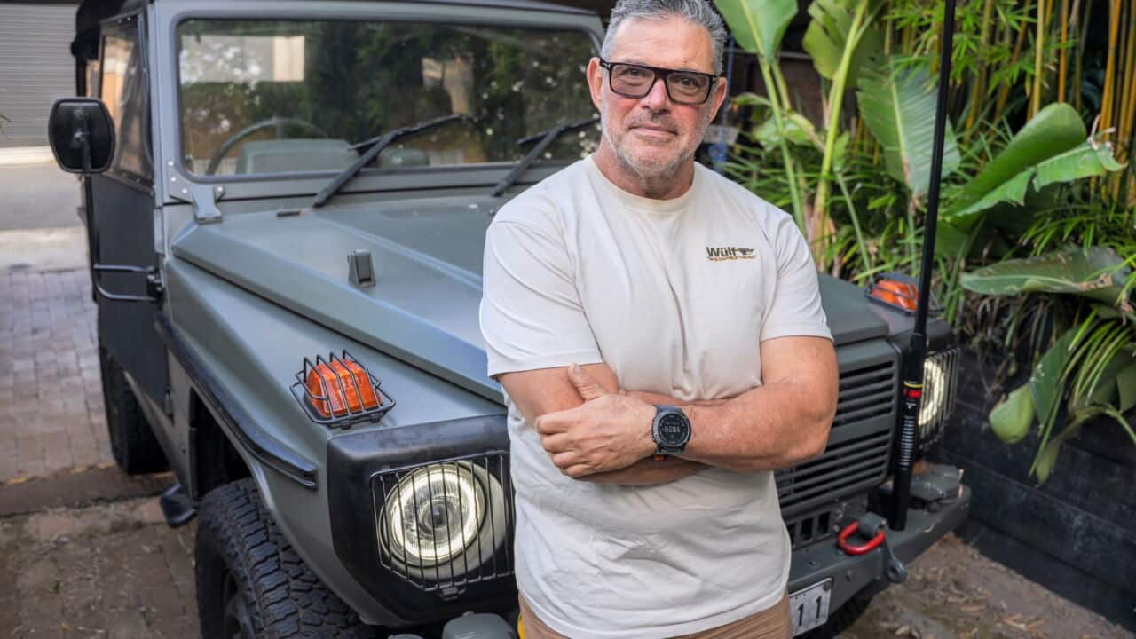 Dr Adrian Cohen with his battery powered cross-country vehicle (SBS-Spencer Austad).jpg