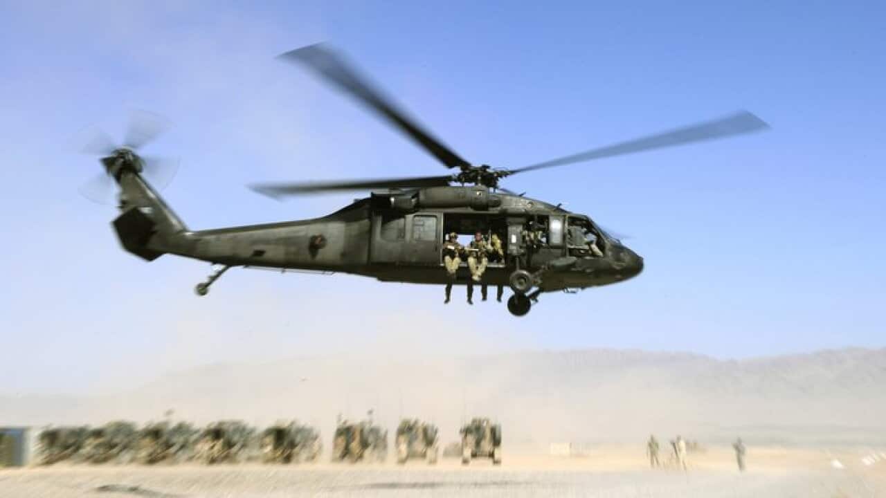 Afghan Officers from the Provincial Police Response Company and Australian Special Operations Task Group Soldiers lift off in a UH-60 Blackhawk helicopter