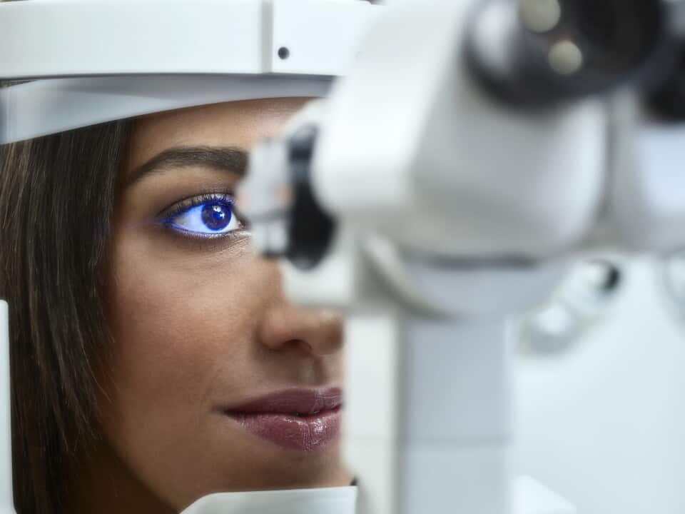 Optician, Young woman during eye test