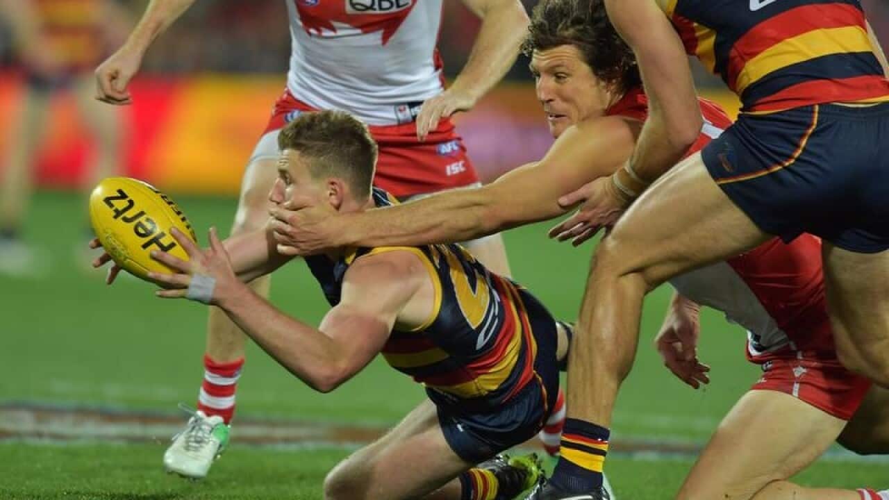 Rory Laird of the Crows and Kurt Tippett of the Swans.