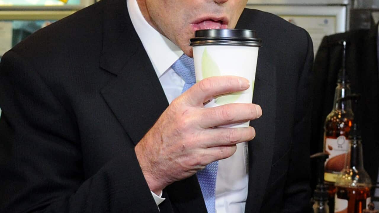 Tony Abbott drinks a coffee during a visit to a small business at Mortdale in Sydney's south.