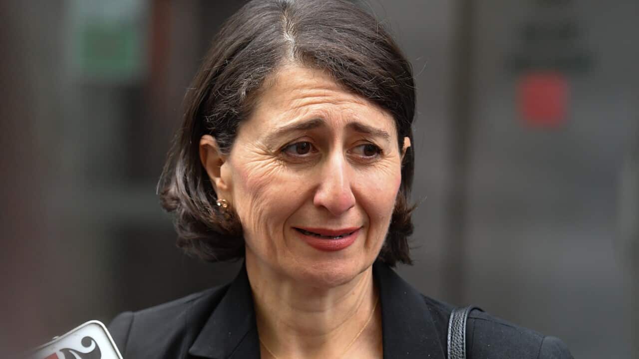 Gladys Berejiklian with a press microphone below her.