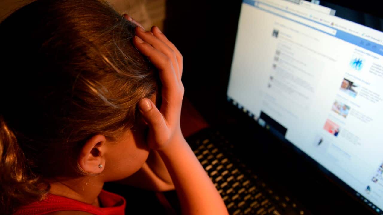 A young girl upset in front of her computer (AAP)