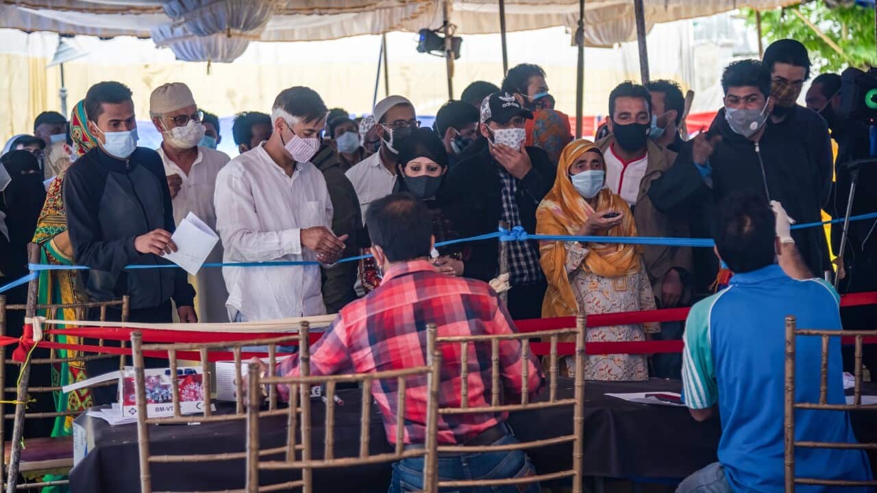 People wait to get tested at a COVID-19 testing centre in Srinagar, India
