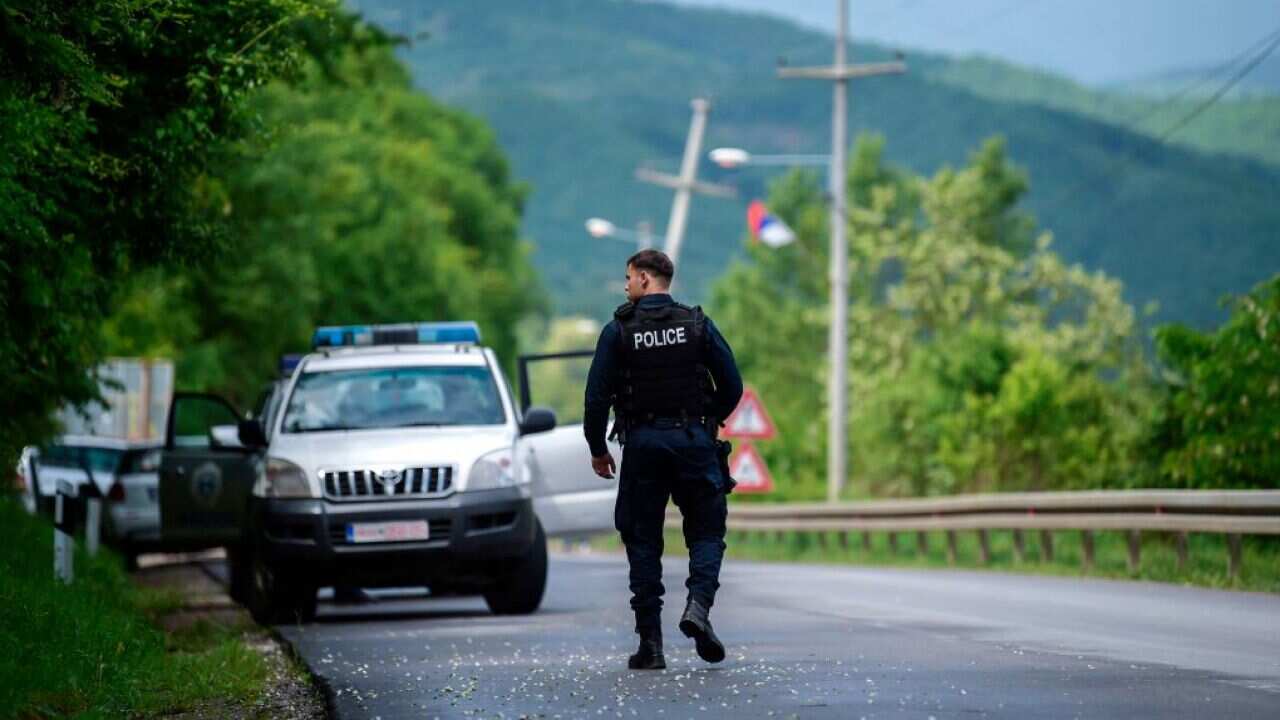 A member of the Kosovo Police Special Unit secures the area near the village of Cabra, near the town of Mitrovica.