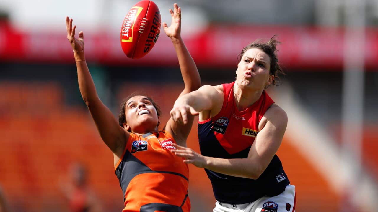 Haneen Zreika (left) of the Giants contests the ball during an AFLW match.
