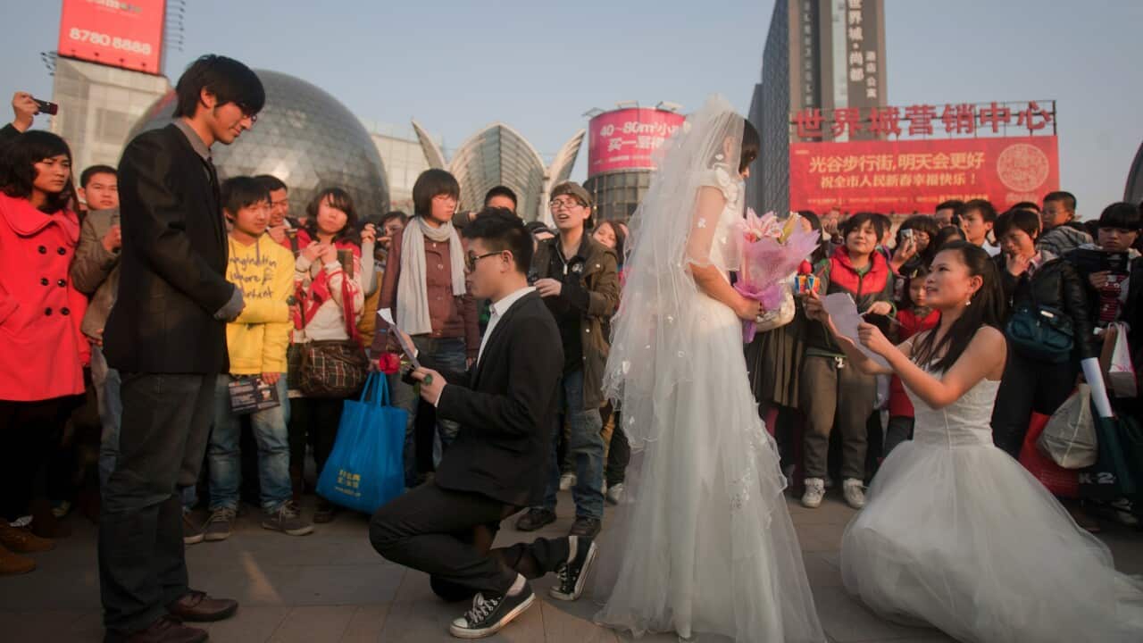 Two couples hold a ceremonial wedding at a shopping plaza in Wuhan as they try to raise awareness of same-sex marriage.