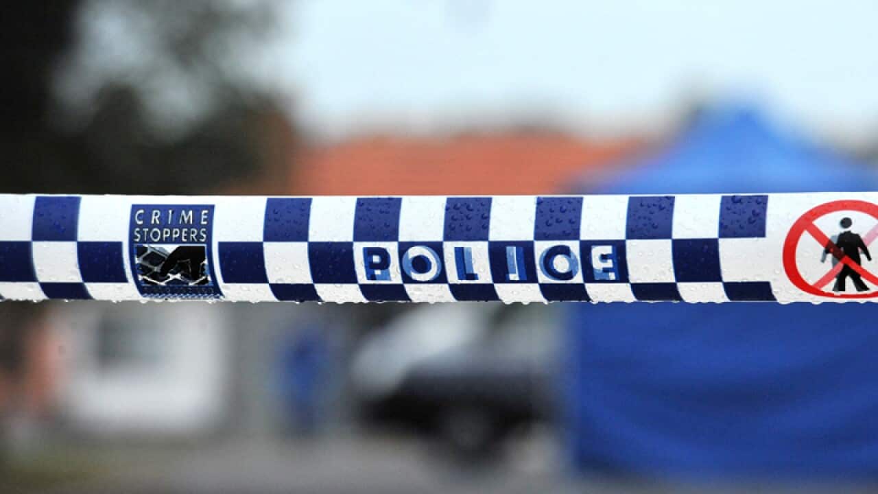 Police tape restricts access to a crime scene