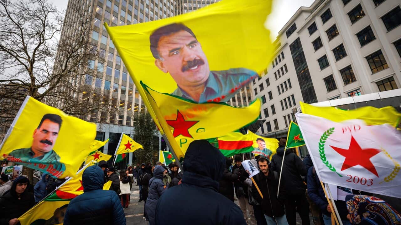 Kurds wave flags and pictures of Kurdistan Workers' Party leader Abdullah Ocalan (AAP)