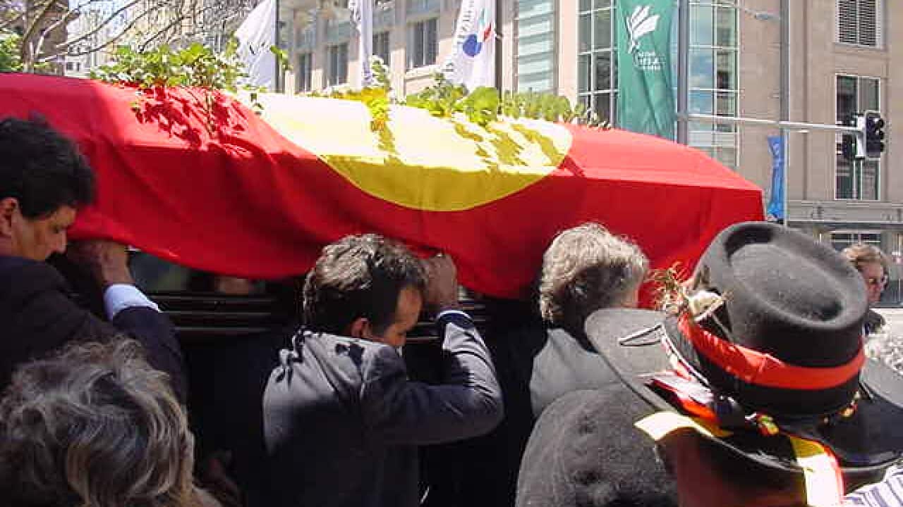 Coffin bearers outside town hall.