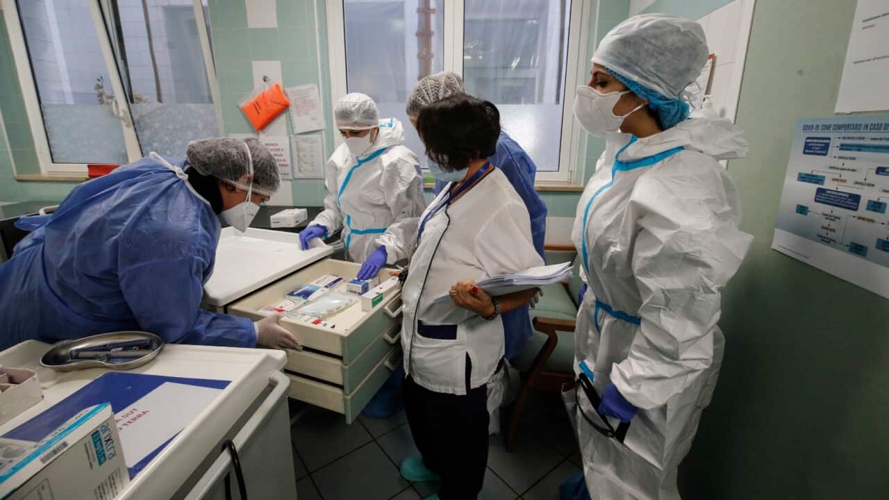 A health worker prepares a Pfizer-BioNTech vaccine against COVID-19.