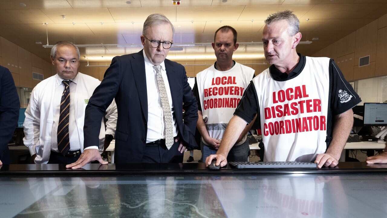 Gold Coast Mayor Tom Tate (left) and Australian Prime Minister Anthony Albanese look on as Local disaster coordinator Mark Ryan (right) displays damaged areas on a map at the Gold Coast Emergency Management Centre on Tuesday, January 9, 2024.
