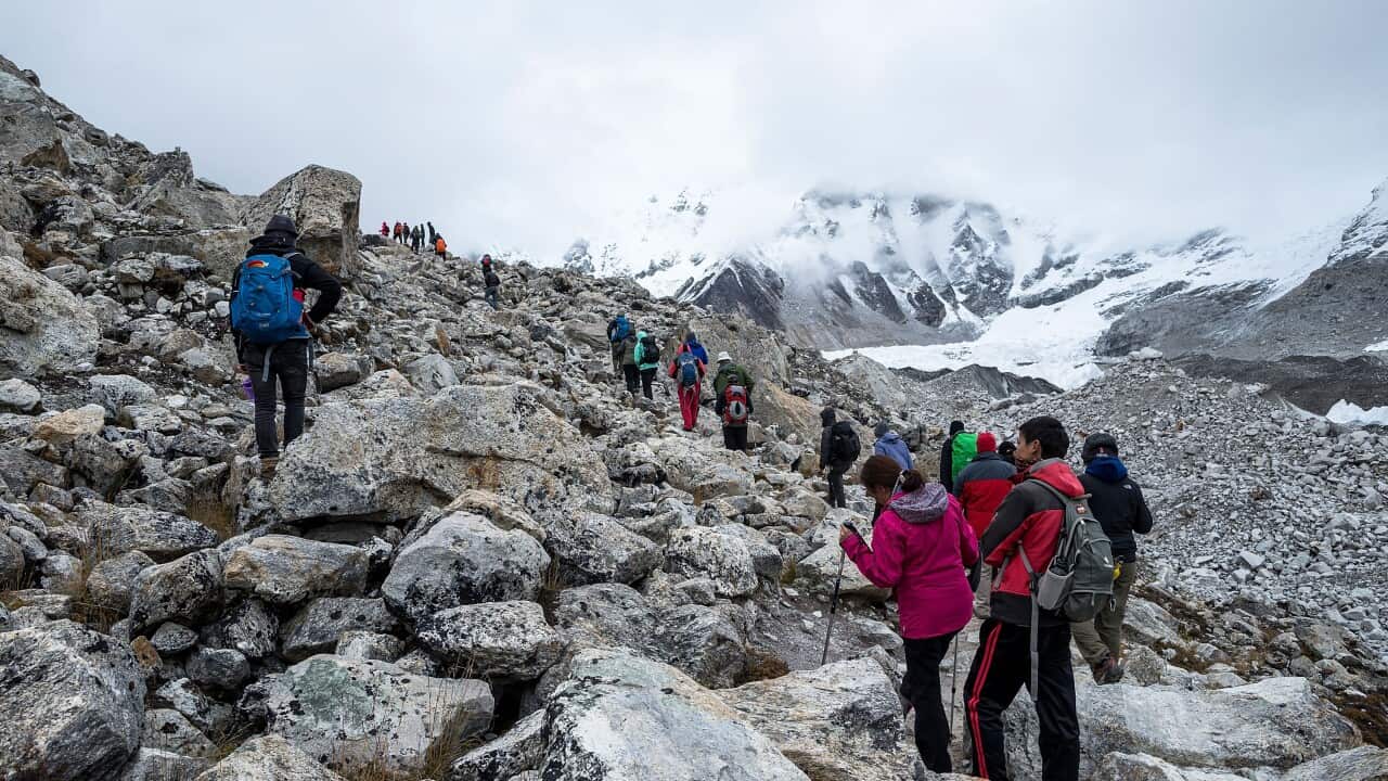 A group of people is climbing a mountain.